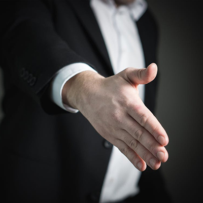 Person reaching out to shake hands and congratulate