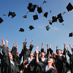 graduates throwing their caps up in the air