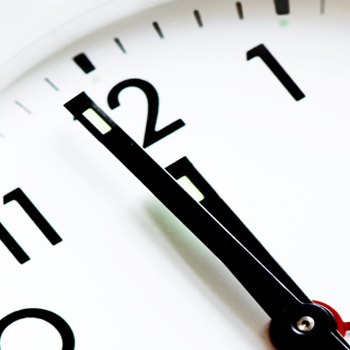 close up of a clock as it approaches midnight