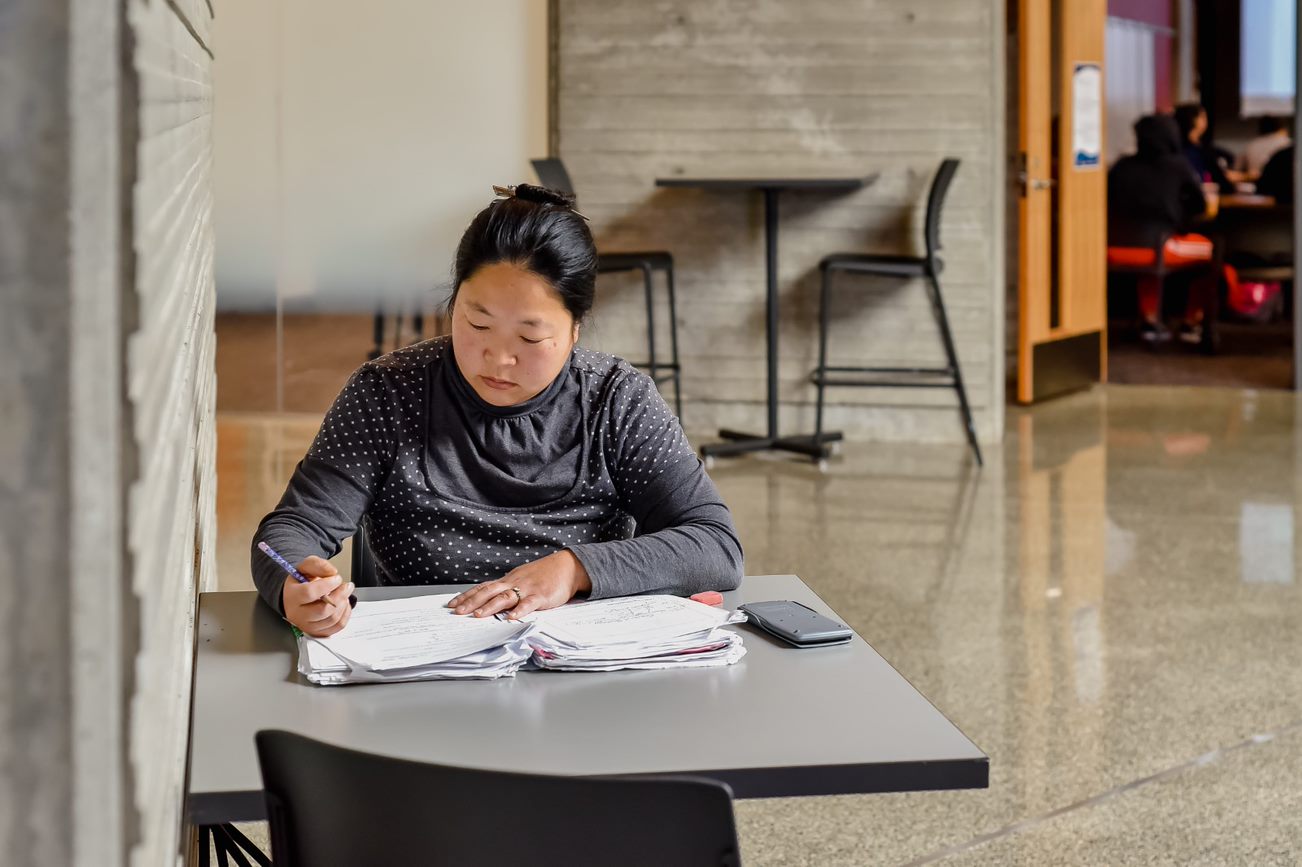 Student studying in the hallway