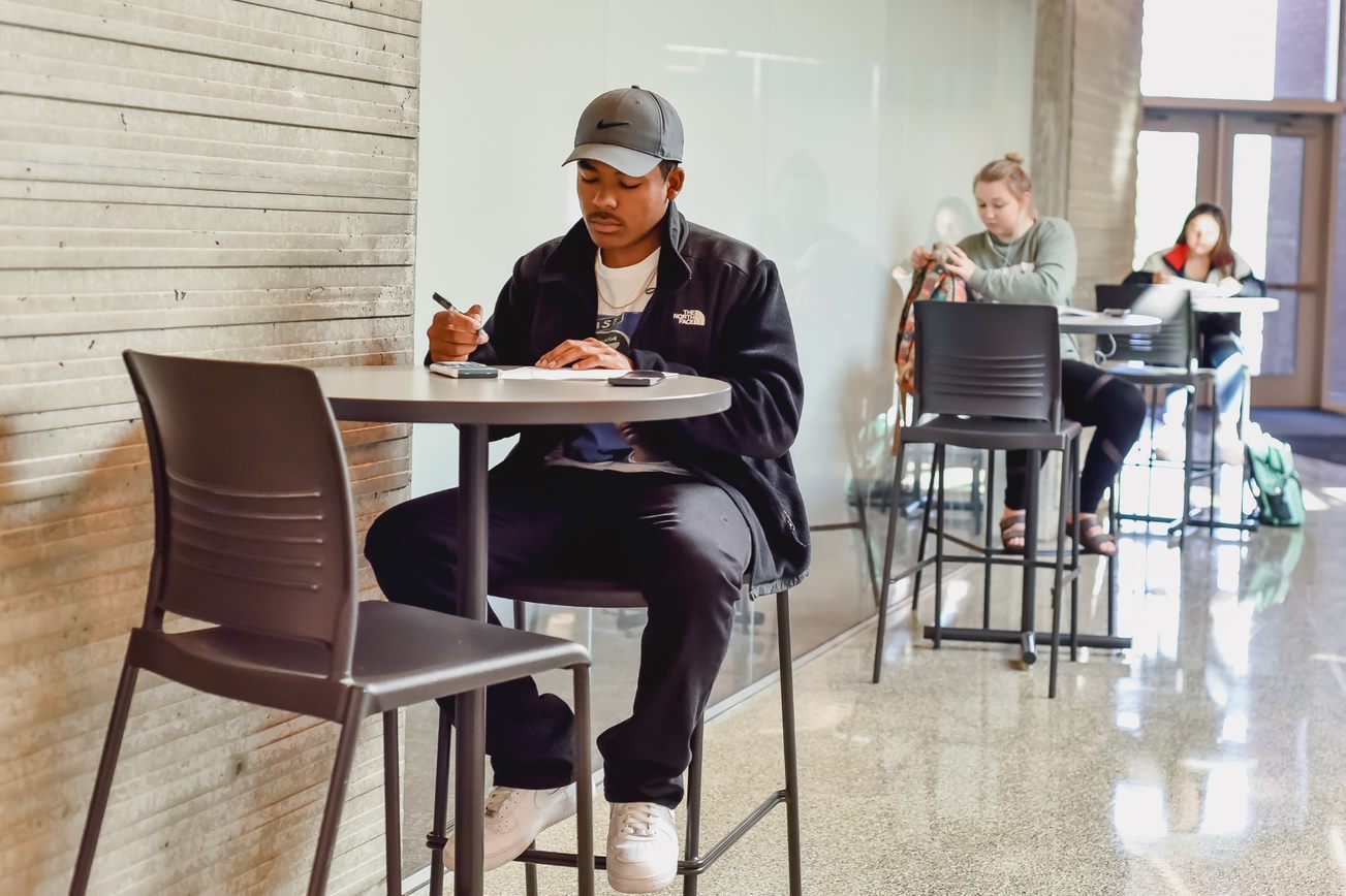 GHC Students sitting at separate tables studying