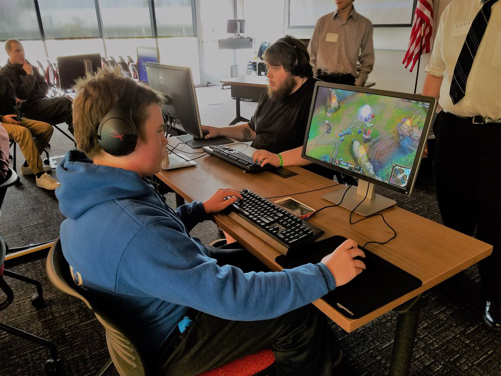 GHC Student sitting at a computer playing a game