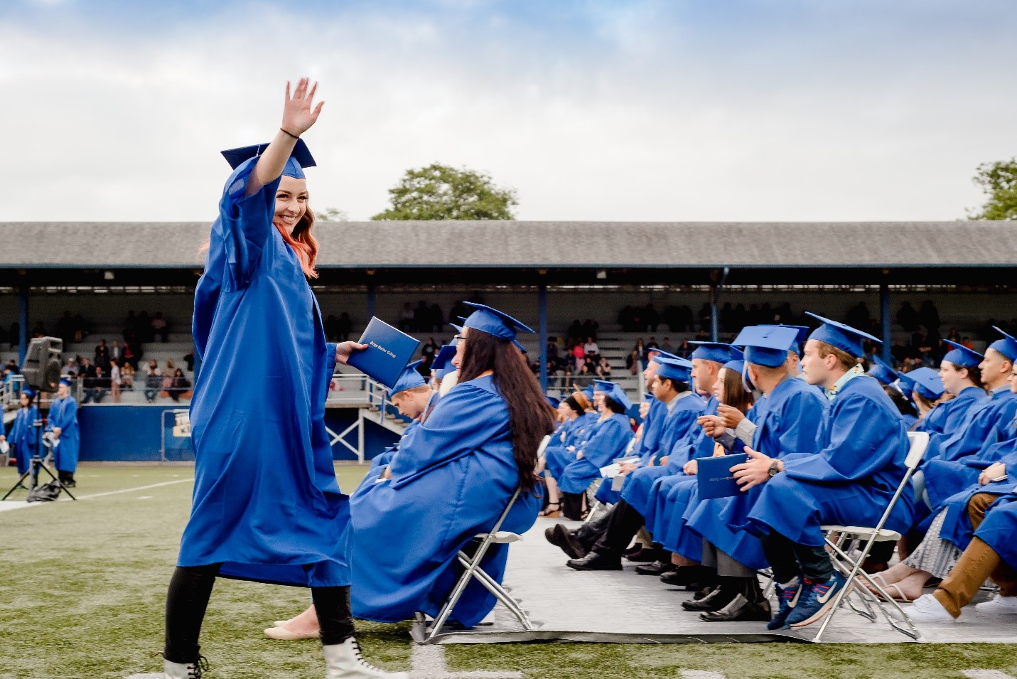 Grays Harbor College student walking with a diploma during graduation