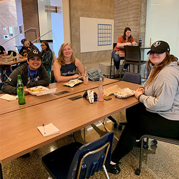 Vanessa Mondragon Williams, Shaela Rehak, and Alexis Good, members of ASGHC’s Executive Board, enjoy lunch and live music before leading tours at New Student Orientation.