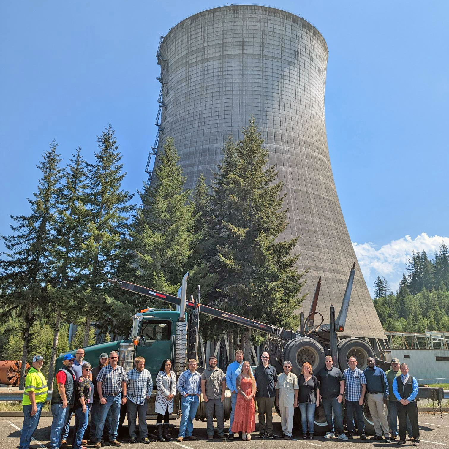 GHC CDL graduates and instructors pose for a photo in front of a log truck that was donated by Sierra Pacific Industries