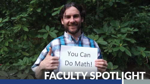 Photo of Patrick Martin holding a sign that says You Can Do Math