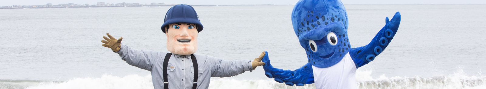 GHC and SPSCC mascots high fiving on Westport beach 