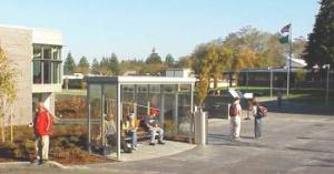 students at bus stop near Spellman Library