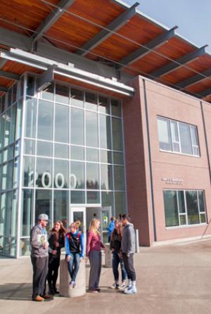 GHC students outside the 2000 building on a sunny day.