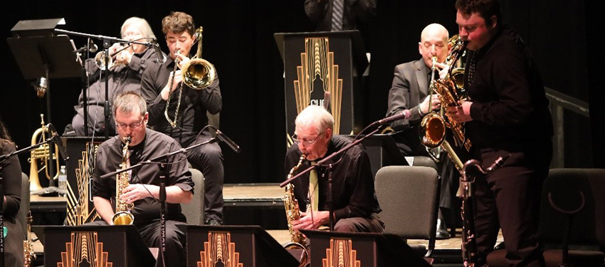Jazz Band members playing instruments on stage