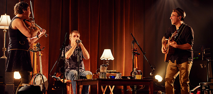 Band members on stage playing instruments