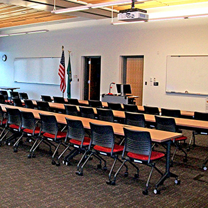 Chairs lined up along three different tables in a conference room