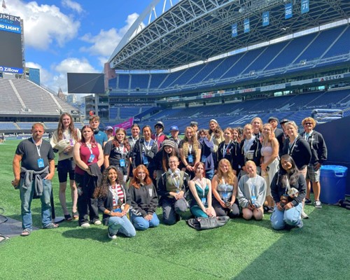 Trio Upward Bound Students in a group photo on the playing field at Lumen Field in Seattle
