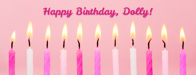 Candles on a birthday cake and text that says Happy Birthday, Dolly!