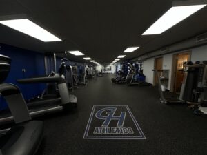 A photo of the Grays Harbor College gym, the GHC logo is on the floor and there are side rooms visible