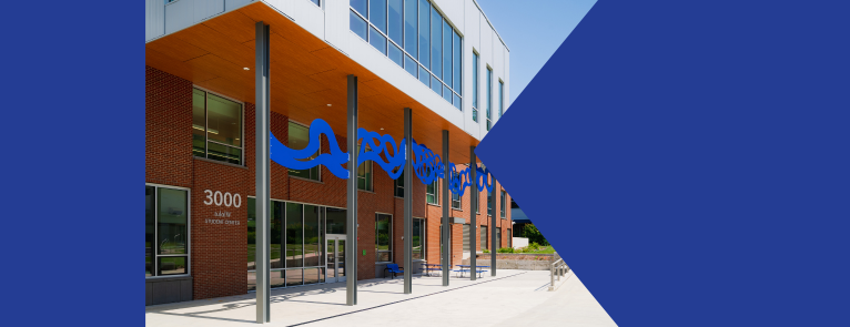 On a dark blue background is an image of the 3000 building with the words Spring Transfer Fair May 14 to the right of the image.