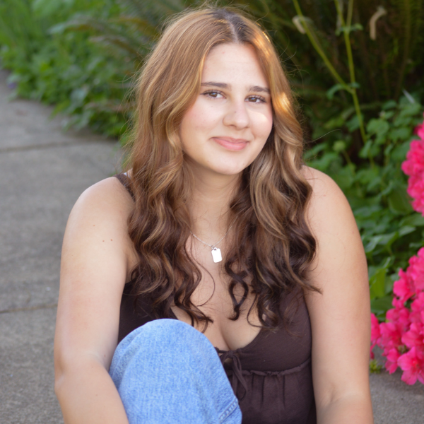 Sasha Leatherman in front of flowers