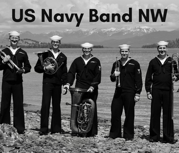 A black and white photo of the US Navy Band, all of them hold horn instruments.