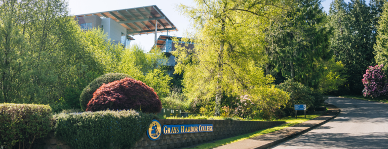 The GHC campus main entrance and the words "GHC to Host The Northwest Commission on Colleges and Universities" over a blue divider.
