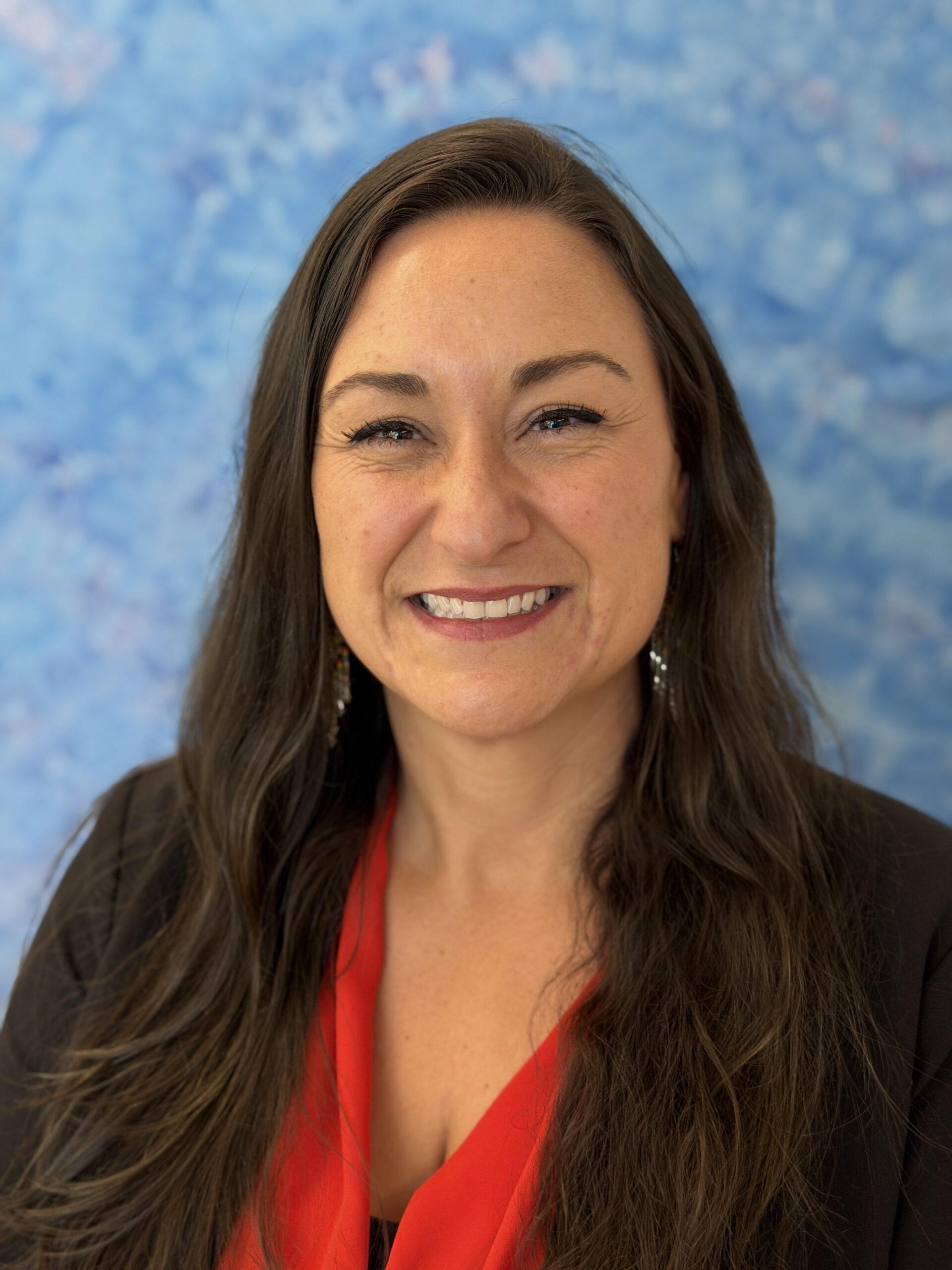 Erin Tofte smiles for the camera in a professional photo