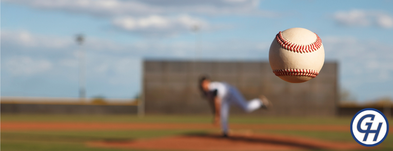 Person throwing a baseball to promote GHC Athletics free Youth Baseball Camp.