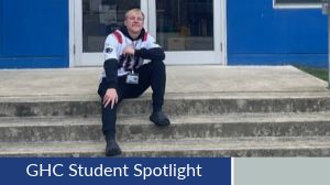 Student Spotlight, Legend Vessey. Legend poses sitting on stone steps outside the athletic building at GHC.